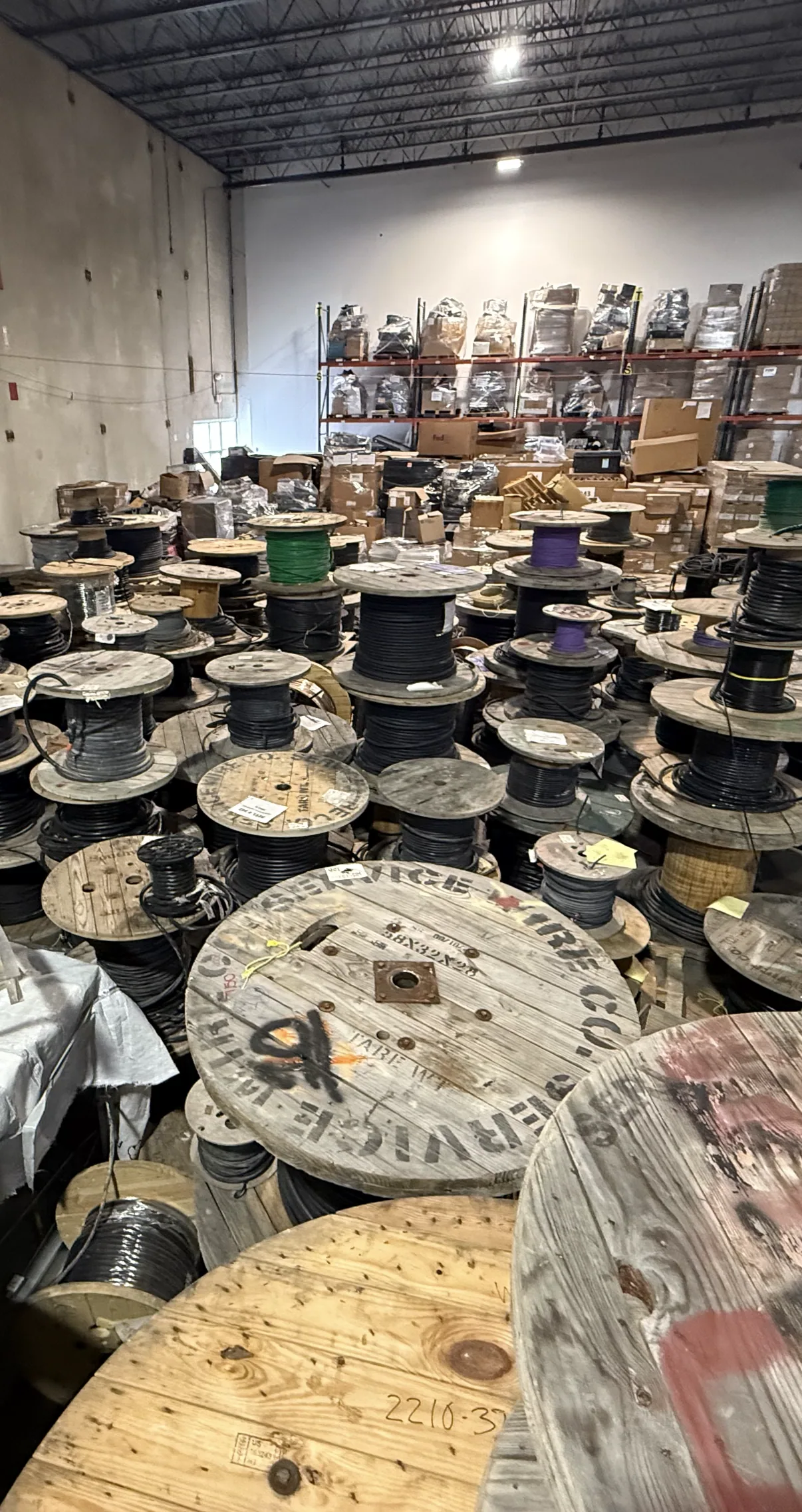 Reels of copper wire and cable stored in a warehouse