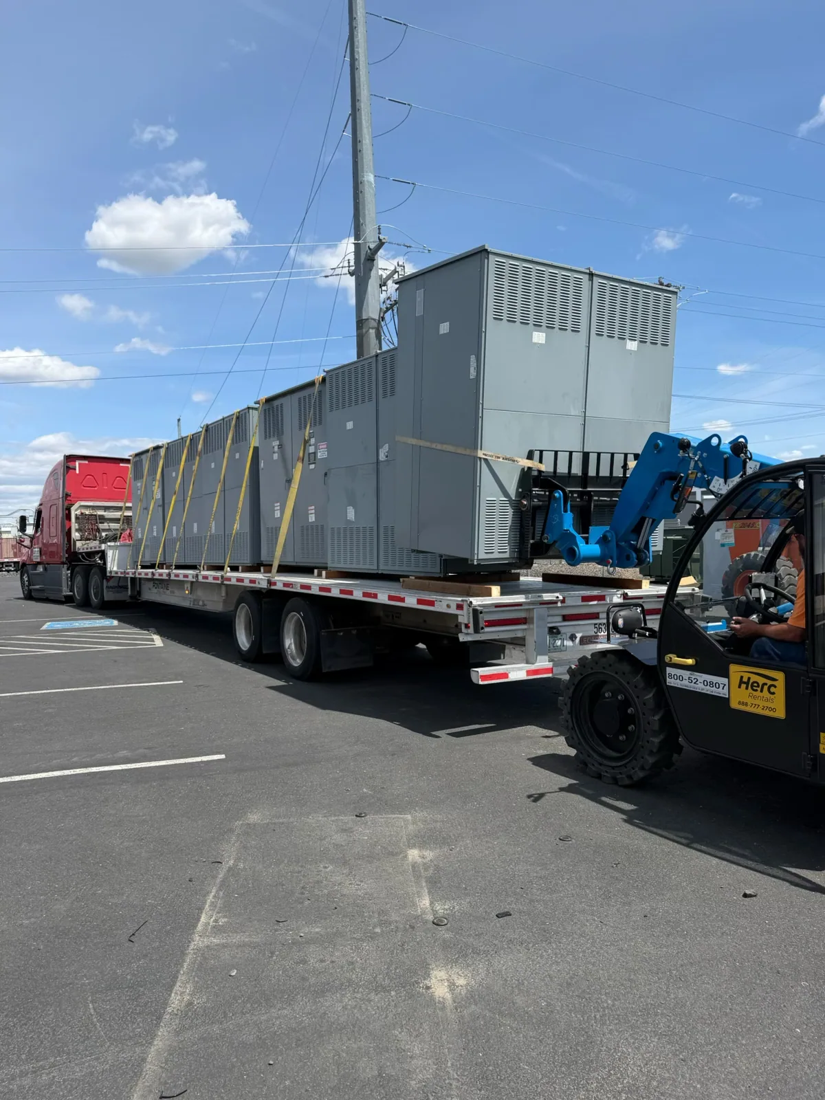 Switchgear sections loaded on a flatbed with a telehandler — Reading, PA