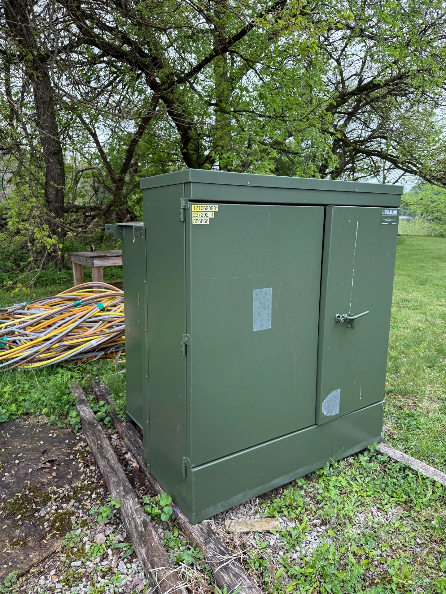 Green pad-mount transformer set on a concrete pad — Cambridge, MA